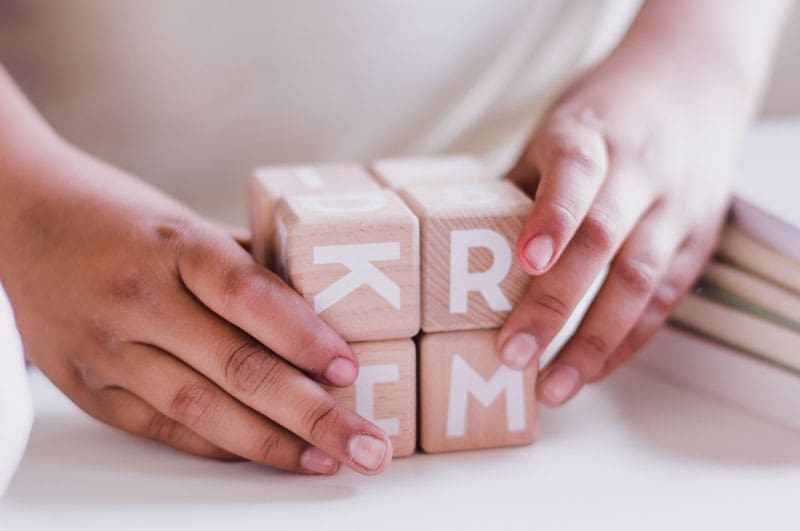 Hands with wooden blocks.
